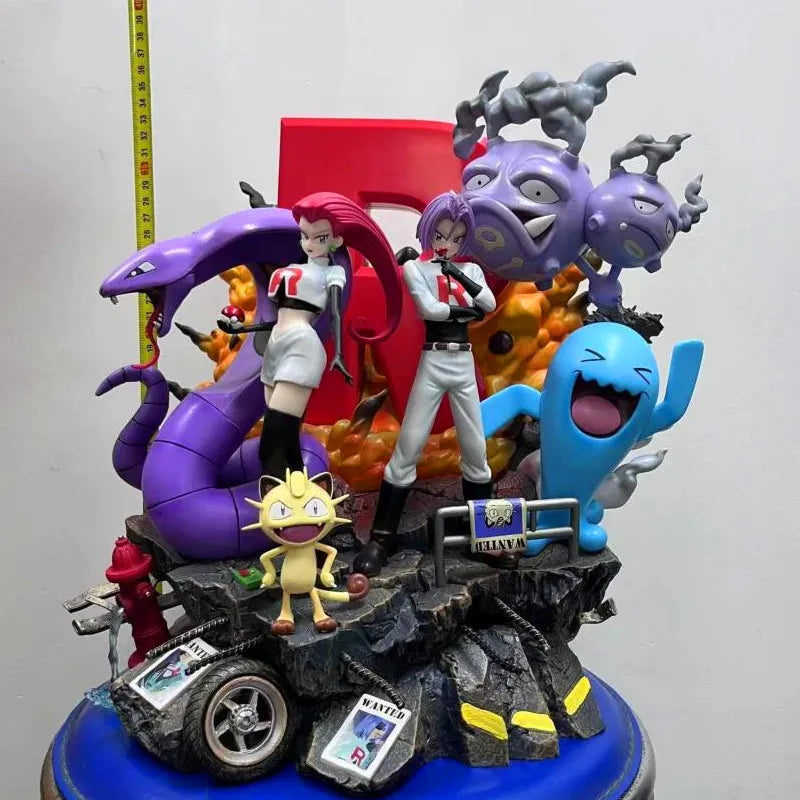 Grande statuette Pokémon représentant la Team Rocket avec Jessie, James, Miaouss et leurs Pokémon emblématiques sur un socle thématique détaillé