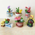 Lot de mini-figurines Pokémon variées présentées sur de petits socles thématiques d'environnement